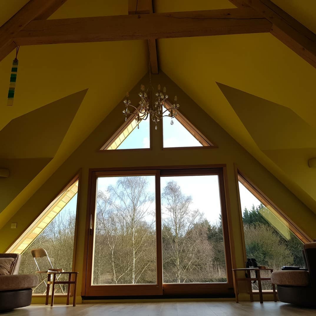 Aluclad timber patio door with directly glazed timber gable